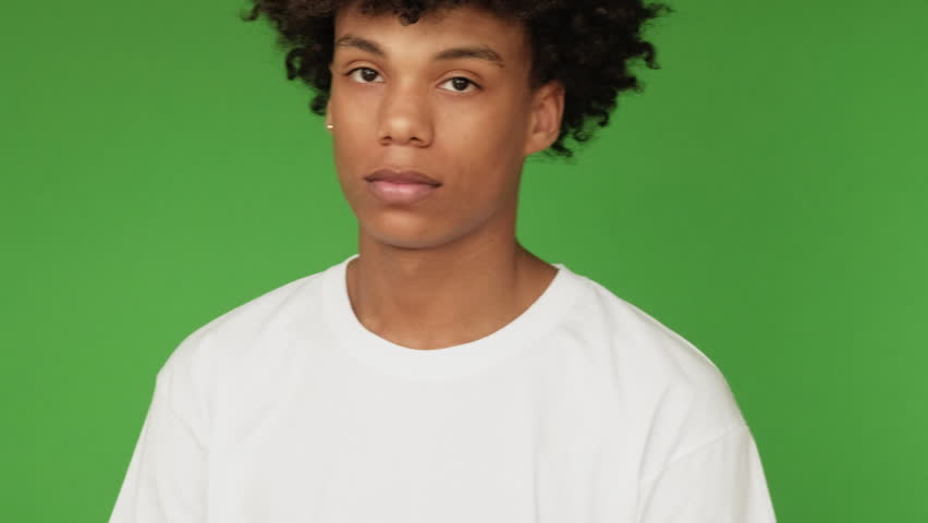 Heart symbol. Affection care. Supportive handsome guy showing romantic adore love you gesture isolated on green free space background.