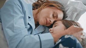 Lazy mom kid lying bedroom interior closeup. Happy girl caring woman enjoying morning ritual at comfortable white pillows. Serene tender family of mother and daughter in pyjamas feeling tranquility - Powered by Shutterstock - Get 15% off with code: PIKWIZARD15