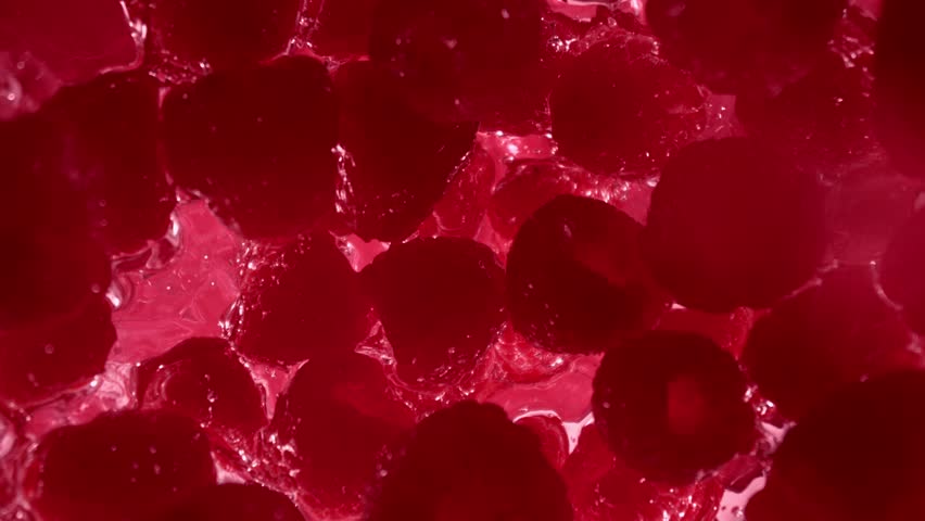 Super Slow Motion Shot of Raspberries Followed by Camera Splashing into Water at 1000 fps.