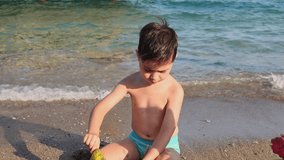 kid playing on beach in sea water swimming,splashing,running or floating on waves.child with sun cap or diving snorkel mask.preschooler boy playing with boat ship toy,digging with plastic shovel. - Powered by Shutterstock - Get 15% off with code: PIKWIZARD15