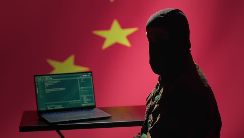 Chinese terrorist using software algorithms on laptop to do fundamentalism propaganda on internet. CCP government secret agent wearing mask sharing dangerous illegal malware online, camera A