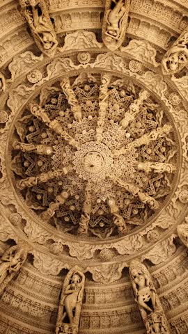 Ceiling of iconic Ranakpur Jain temple or Chaturmukha Dharana Vihara. Marble ancient medieval carved sculpture carvings of sacred religious place of jainism worship. Ranakpur, Rajasthan. India