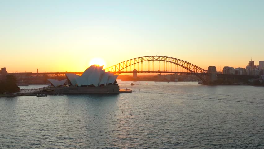 Sydney Opera House Harbour Bridge Vivid Australia aerial drone golden hour sunset Circular Quay Royal Botanic Gardens scenic helicopter flight ferry boats orange sunny skyline left movement