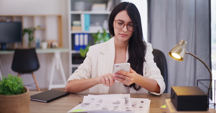 A sad businesswoman receives a bad text message.