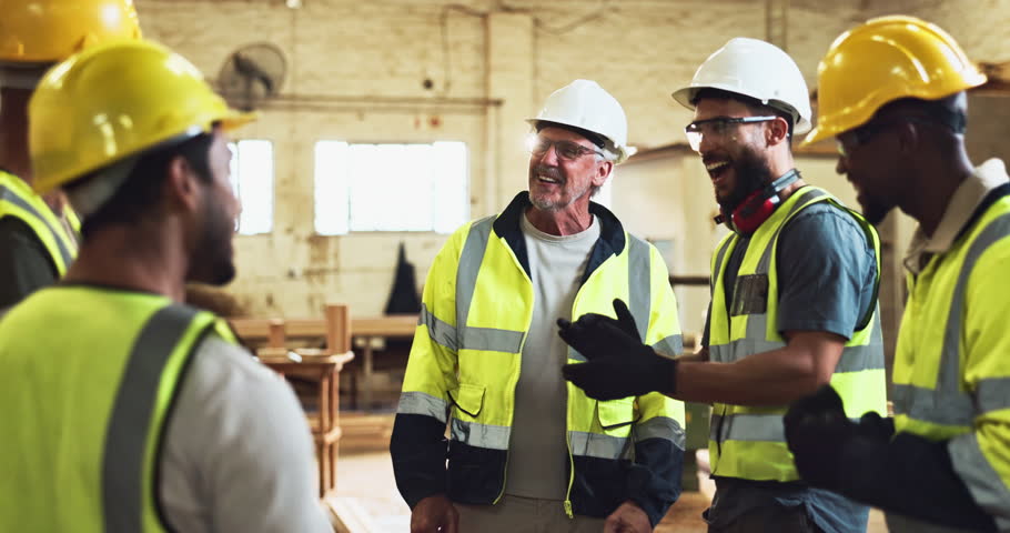 Celebration, construction and handshake with warehouse team in workshop together for project success. Collaboration, hug and well done with carpentry people cheering in factory for manufacturing