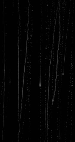 Water flows on the glass door, stream by stream, effect on a black background
