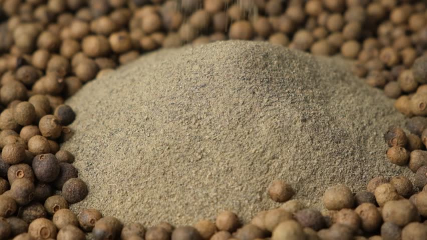 Ground black pepper pouring, slow motion