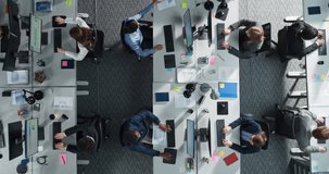 Top Down View: Diverse Team Of Professionals in an Office, Working on Desktop Computers With Documents And Reports. Workspace Of Modern Fintech Startup or Investment Fund With Managers And Analysts. - Powered by Shutterstock - Get 15% off with code: PIKWIZARD15
