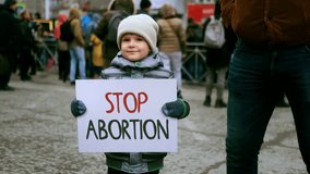Anti murder demonstration city street. Stop abortion protest. Cute little boy hold let baby live placard. Kill ban prohibition. Pro life banner. No roe v wade law. Lot people crowd fight rights. - Powered by Shutterstock - Get 15% off with code: PIKWIZARD15