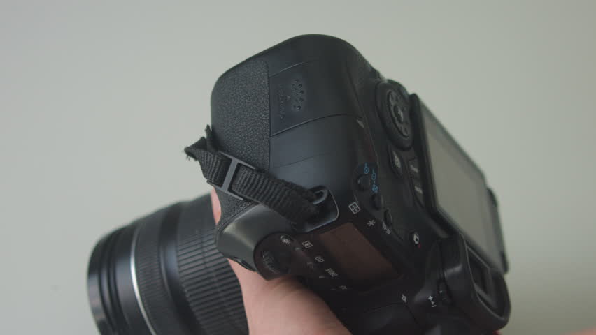Woman Inserting and Removing SD Card in DSLR Close-Up