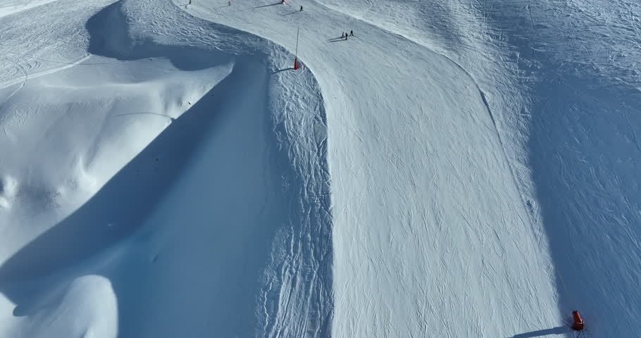 Winter drone shot of ski pistes and slopes covered with fresh powder snow in Tignes in Valdisere France