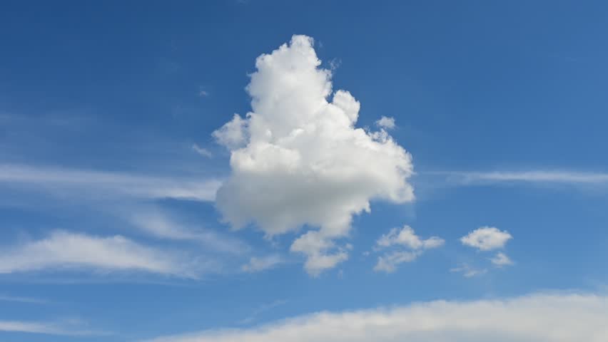 Time lapse, a white cumulus cloud dissolves in the blue sky, disappears