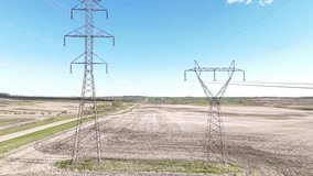 Power line fly through along electrical pylons overlooking seeded agriculture fields in Alberta Canada. - Powered by Shutterstock - Get 15% off with code: PIKWIZARD15
