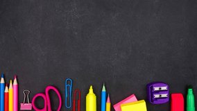 Colorful school supplies bottom border with up down motion. Overhead view on a black chalkboard background. Back to school concept. - Powered by Shutterstock - Get 15% off with code: PIKWIZARD15