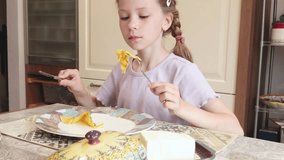 Teenager eats pancake at home in kitchen that she made herself. Food and cookery. Hobbies and kids. - Powered by Shutterstock - Get 15% off with code: PIKWIZARD15