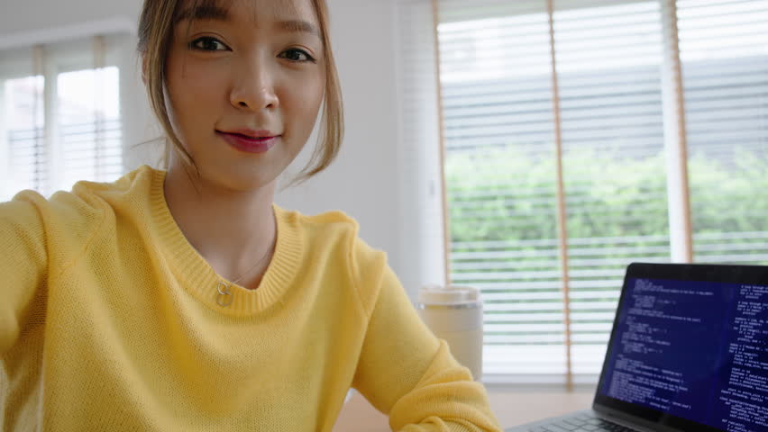 POV Young adult asia Gen z girl relax smile face WFH look at camera take photo shoot snap shot show share using snapchat app send post viral video vlog IG reels story instagram. Fun joy work at home.