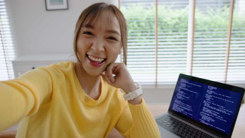 POV Young adult asia Gen z girl relax smile face WFH look at camera take photo shoot snap shot show share using snapchat app send post viral video vlog IG reels story instagram. Fun joy work at home.