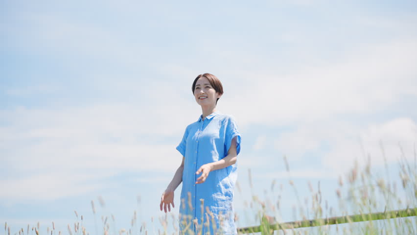 Lifestyle image of a young woman taking a deep breath