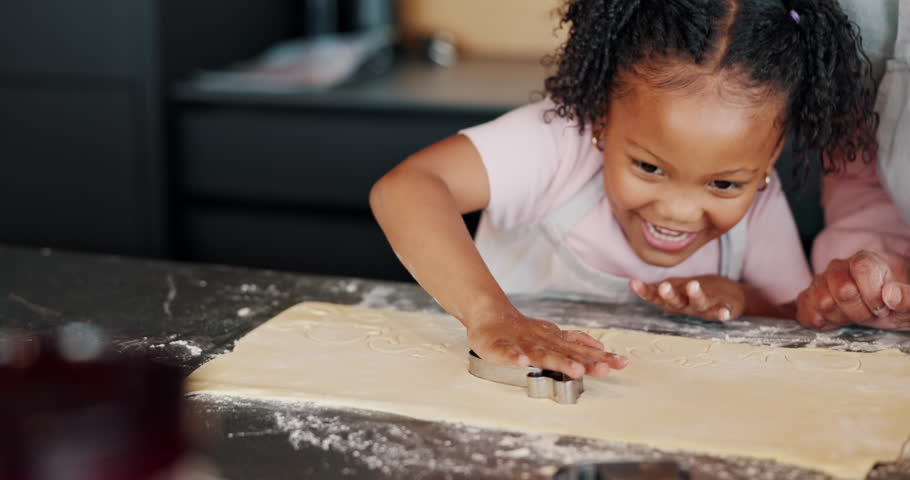 Grandmother, girl and baking with cookie cutter for dessert, food and family in kitchen with recipe. Snack, teaching and childhood development for young person, granny and cooking with ingredients