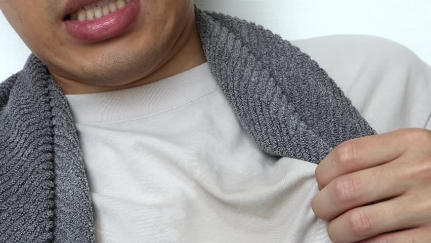 This man's shirt is wet with sweat.