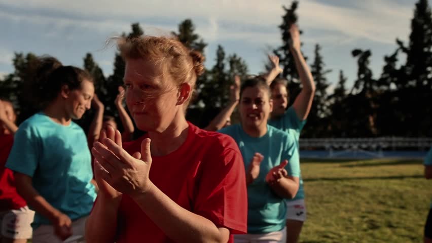 Female rugby players in red and blue jerseys congratulating and applauding each other after a match. Female Rugby Teams Congratulating Each Other After Match - Powered by Shutterstock - Get 15% off with code: PIKWIZARD15