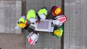 Top view of architectural engineering discussion at construction site and his blueprints planning project on precast concrete, Cement slab floor concrete slab stacked construction site.meeting, - Powered by Shutterstock - Get 15% off with code: PIKWIZARD15