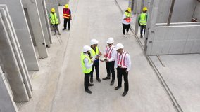 Top view of architectural engineering discussion at construction site and his blueprints planning project on precast concrete, Cement slab floor concrete slab stacked construction site.meeting, - Powered by Shutterstock - Get 15% off with code: PIKWIZARD15