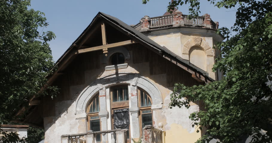 tilt down shot of an abandoned building with balconies 