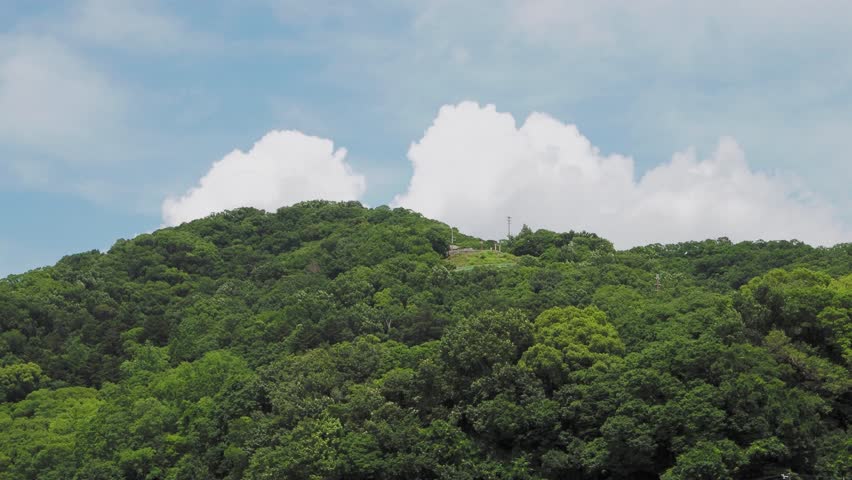 Satsukiyama covered in fresh greenery and cumulonimbus clouds