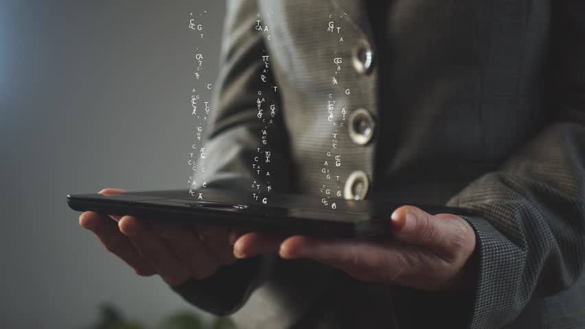 A businesswoman holds a graphics tablet above which there is a hologram with three DNA chains consisting of letters of the Latin alphabet. The concept of personification of the genetic code. Cg - Powered by Shutterstock - Get 15% off with code: PIKWIZARD15
