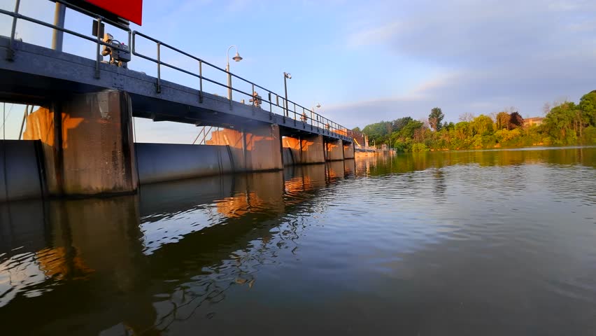Fast exciting FPV drone flight over tranquil waters by the dam.
