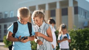 Children using smartphones outside. Social interaction among children with smartphones. Group of kids engaged with mobile devices. Children enjoying technology outdoors. Social activity smartphones - Powered by Shutterstock - Get 15% off with code: PIKWIZARD15