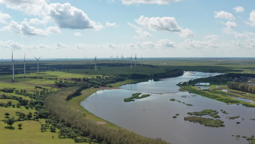 Aerial photography of windmills on the grassland in Duerbert County, Daqing City, blue sky and white clouds