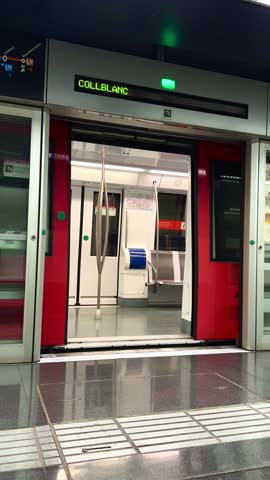 Stock video of moving subway train at metro station. Blurred metro in movement. Doors of the subway car are closed and train departs. Collblanc Station