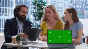 Financial advisor showing data graphs on green screen notebook to customers, analyzing market trends to do forecasting. Clients checking investment plan on chroma key laptop, camera B - Powered by Shutterstock - Get 15% off with code: PIKWIZARD15