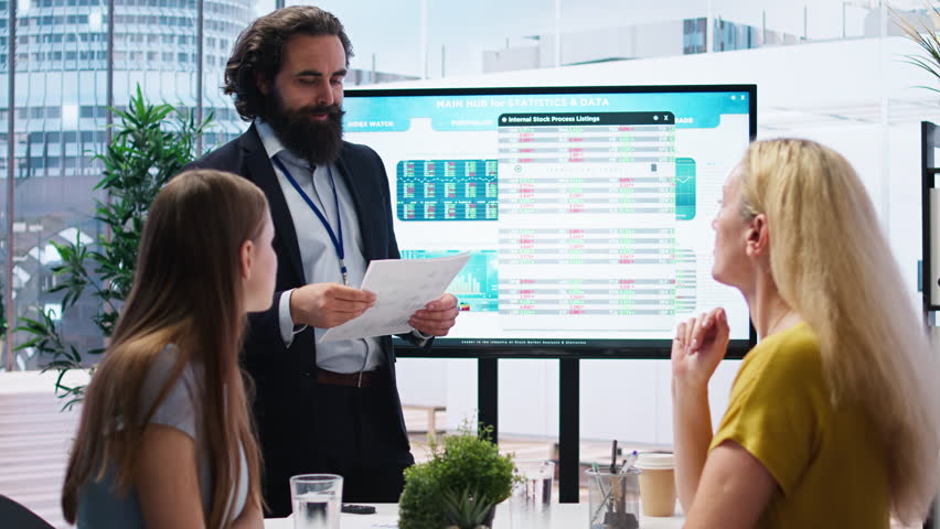 Financial advisor discussing with clients, recommending suitable financial products such as mutual funds. Agent teaching parent and daughter how to invest, offering statistical graphs, camera A - Powered by Shutterstock - Get 15% off with code: PIKWIZARD15