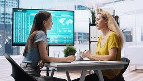 Financial advisor showing data graphs on big screen to customers, analyzing market trends to do forecasting. Mom and gen Z girl checking investment plan on display made by agent, camera A - Powered by Shutterstock - Get 15% off with code: PIKWIZARD15
