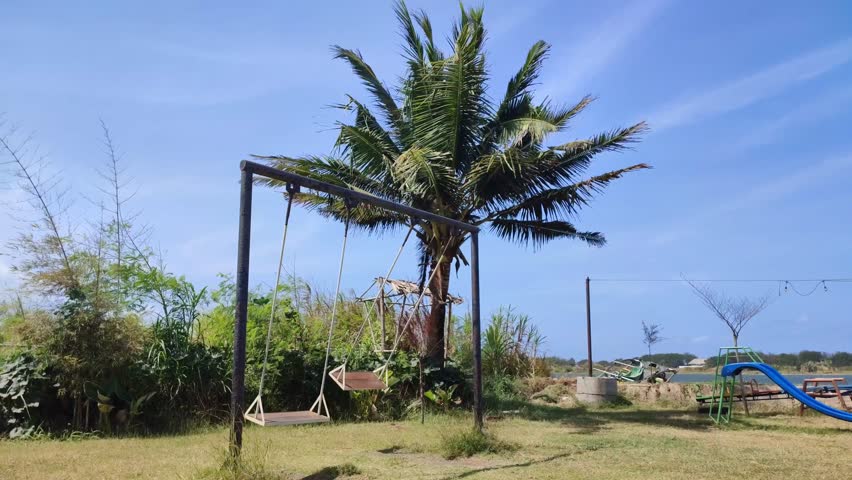 Two swings in the park rocking themselves