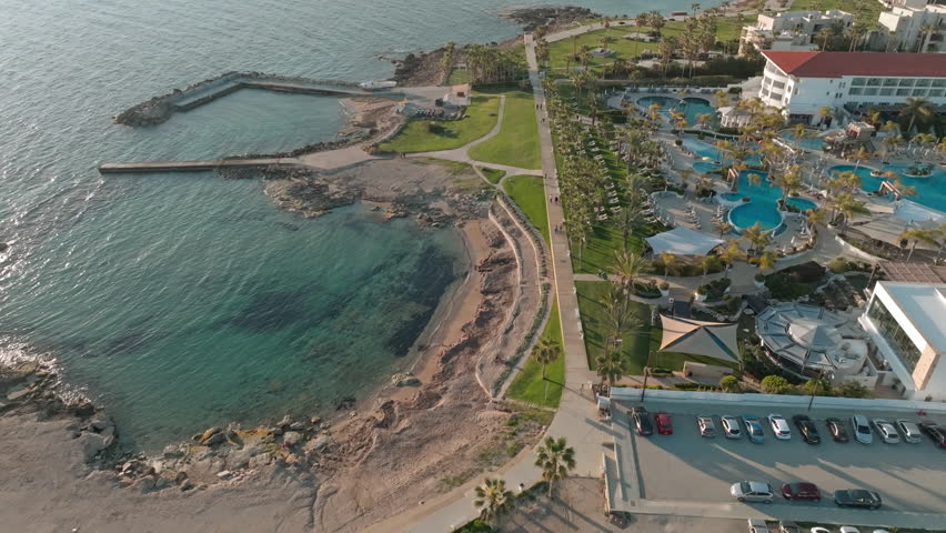 Aerial view tourist coastline with resorts in Paphos, Cyprus. Beautiful turkish island in the mediterranean sea villas with swimming pools. High quality 4k footage