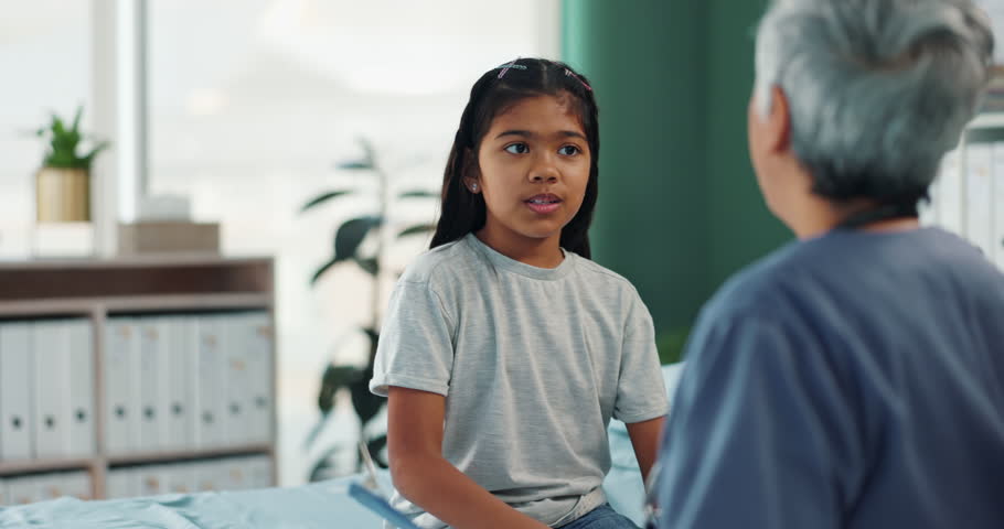 Girl, doctor and talking in hospital for health, wellness and medical advice with consultation or checkup. Child, pediatrician and sick with symptoms in clinic for diagnosis and healthcare assessment