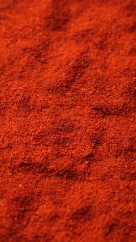 Heap of red smoked paprika or Chili pepper, rotation. sstkVertical