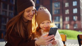 Mother and Daughter Look at Phone in Springtime - Powered by Shutterstock - Get 15% off with code: PIKWIZARD15