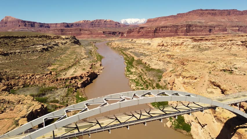 Aerial view of Colorado River and Utah State Route 95, Hite Crossing bridge with scenic rock formations, Lake Powell, Utah, United States.