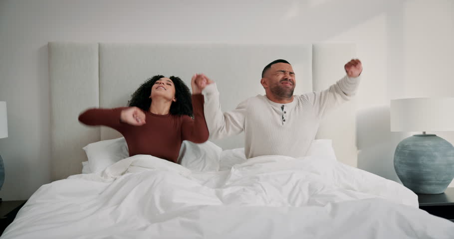 Happy couple, bedroom and stretching with wake up, morning and smile as married people in home. Woman, man and positive for rest, together and excited for weekend, partner and relationship with care