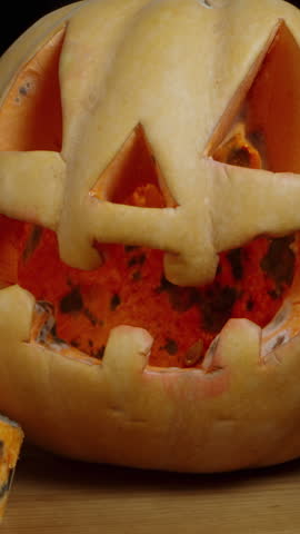 Vertical video. Last Year's Jack-O'-Lantern Covered in Mold and Wrinkled. Dolly Slider, Close-Up.