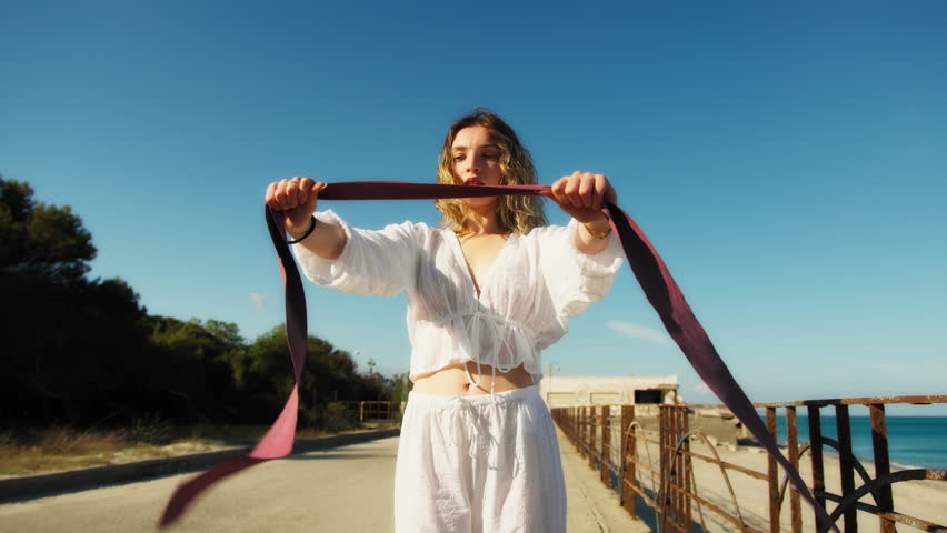 Young Woman Exercises Muscles At Elastic Gym Outside