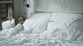 Happy girl falling bed in sunlight. Closeup cheerful woman jumping having fun in morning home. Joyful curly blonde enjoying time alone resting soft white bedding zoom on. Weekend happiness concept. - Powered by Shutterstock - Get 15% off with code: PIKWIZARD15