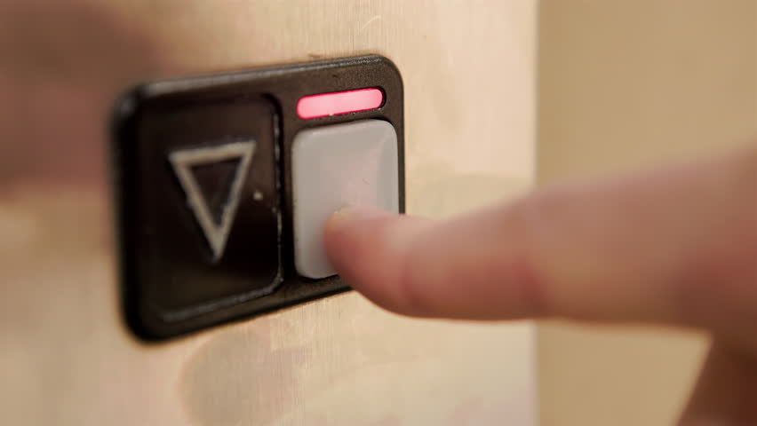 Close up detail of finger pressing elevator signal button to go down 4k