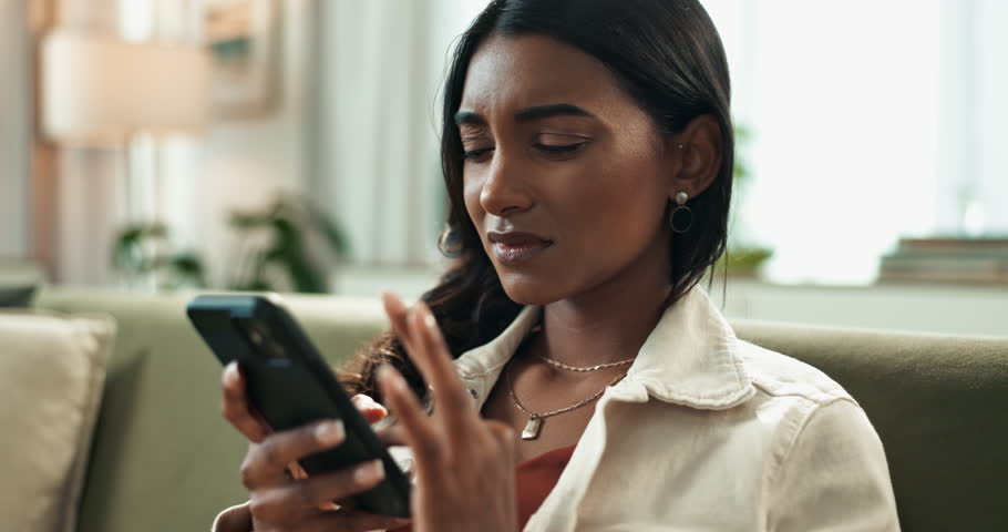 Woman, smartphone and reading message in home, mobile app and virtual person or cancelling plans with text. Upset, disappointed notification and failed online date, living room and communication