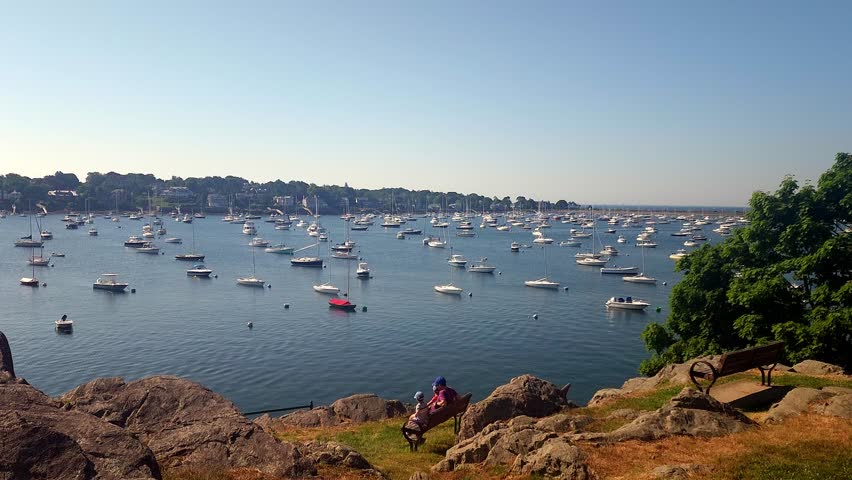 A father and his sons looking out at Marblehead Marina from Crocker Park